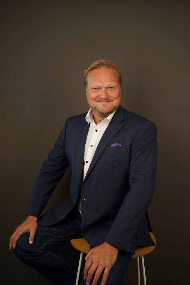 Votech's CEO, Jari Kaitera, sitting on a chair smiling